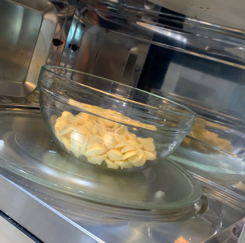 Using a microwave, temper white chocolate wafers. Heat for 30 seconds, then for 15-second intervals. Temper until chocolate is 87-88 degrees Fahrenheit.
